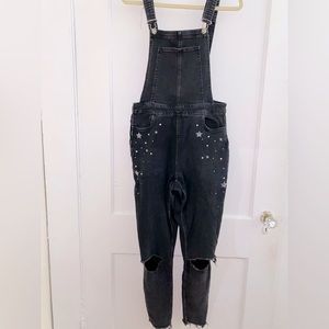 Black fitted overalls with stretch, star + sparkle detail on hips